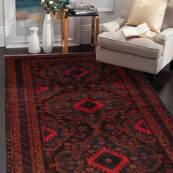 Handwoven tribal rug with symmetrical patterns in deep black, navy, and copper, ideal for living rooms and hallways