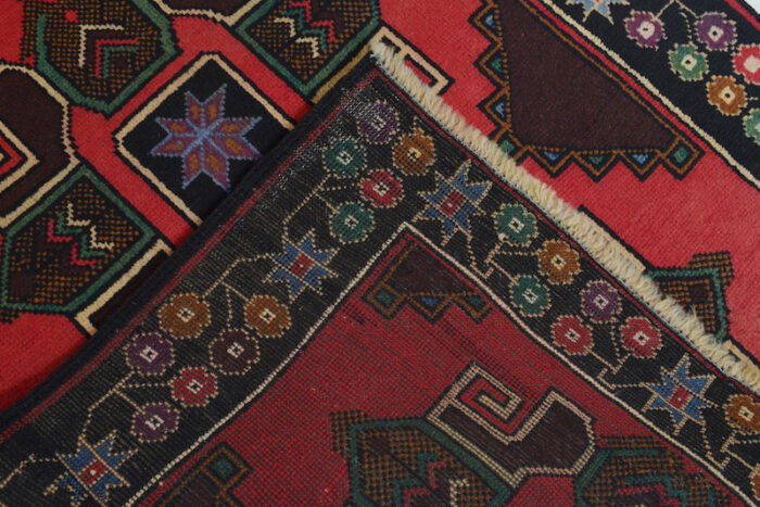 Handwoven Baluchi tribal rug in rich red and navy with floral borders. 4'7 x 2'10 ft durable wool rug, ideal for high-traffic areas and cozy spaces