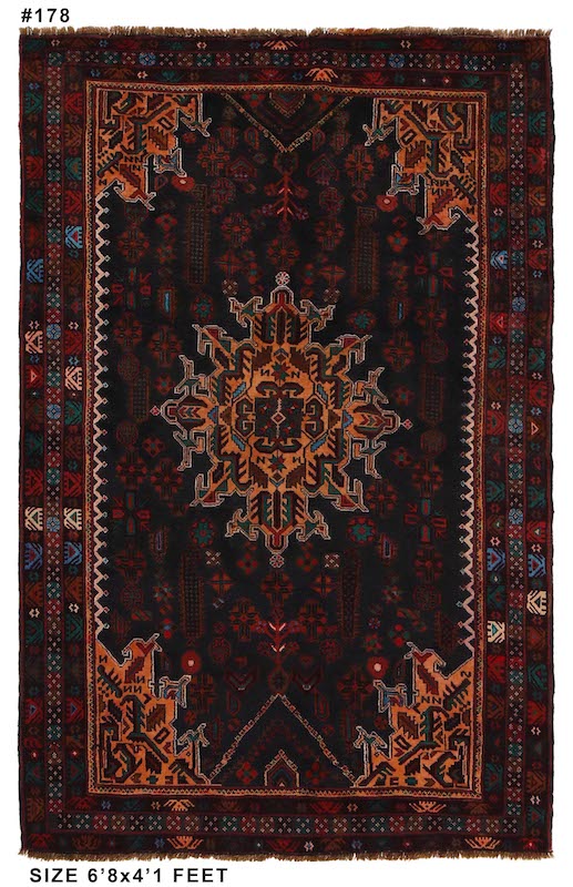 Authentic Afghan tribal wool rug with bold medallion motifs in black and rust. 6'8 x 4'1 ft, washable and available with free USA shipping.